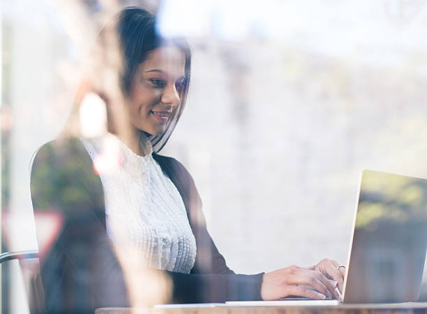 istock Happy businesswoman using laptop in cafe 480985490