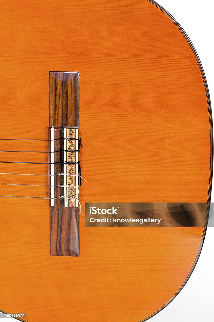 Body of a clasical styal guitar Orange colored guitar body bridge Acoustic Guitar Stock Photo