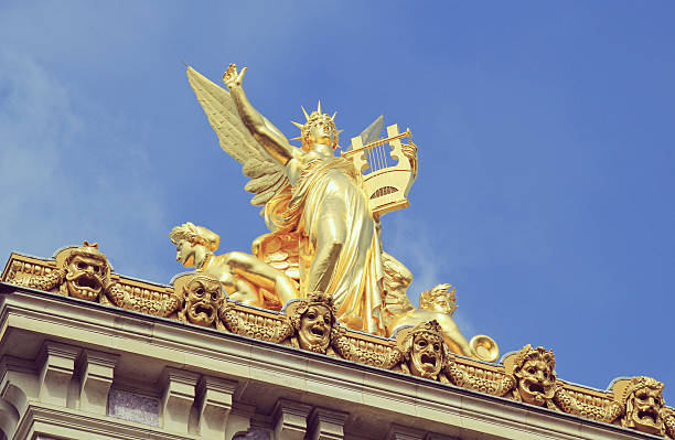 Golden statue, Opera Garnier, Paris. Golden statue on top of the Opera house in Paris. opera stock pictures, royalty-free photos & images