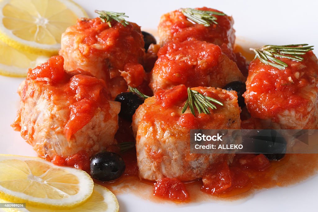 fish in tomato sauce with olives on plate closeup horizontal sea fish in tomato sauce with olives on the plate closeup horizontal 2015 Stock Photo