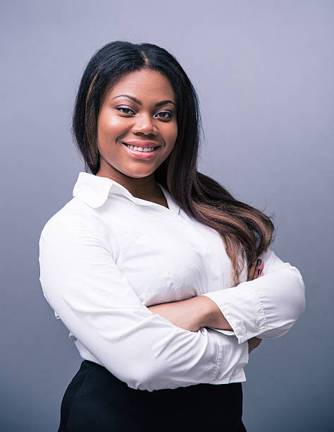 istock African businesswoman standing with arms folded 480989388
