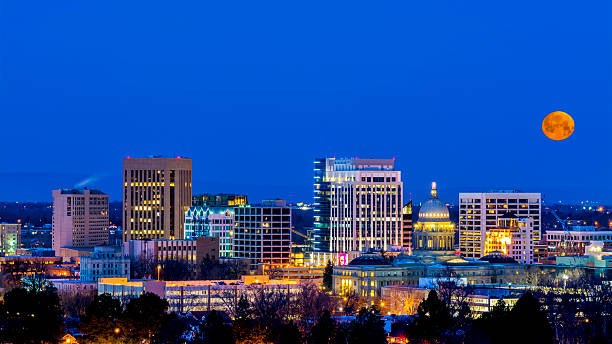 Blue night sky over Boise Idaho with moon stock photo