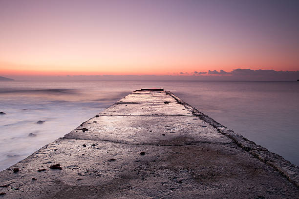 istock sunrise on Black sea rocky shore with old pier 480994781