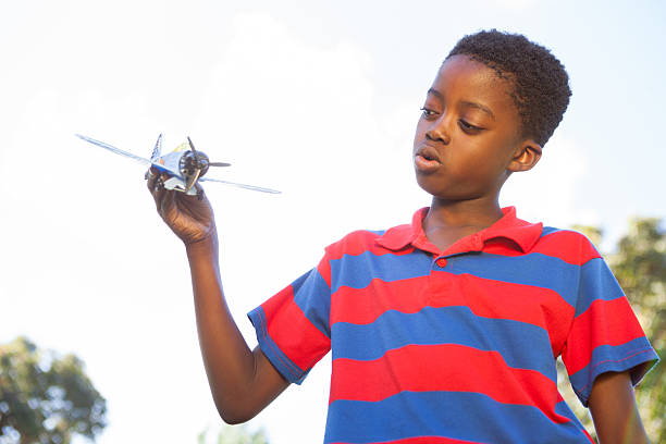 istock Little boy playing with toy airplane 480995030