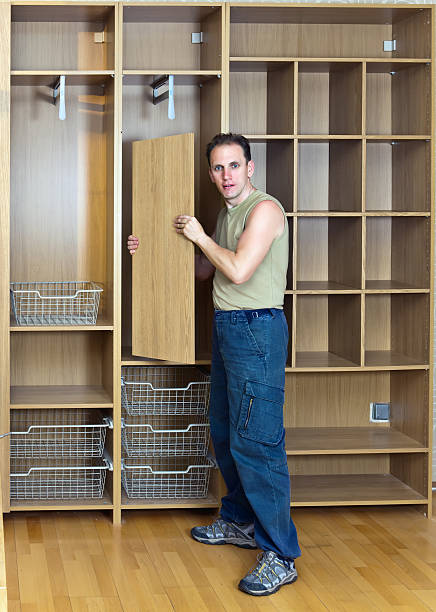 istock The man is engaged in assemblage of a new wardrobe 480995128