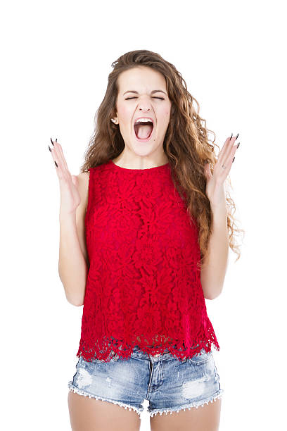 istock girl in red screaming 480995761