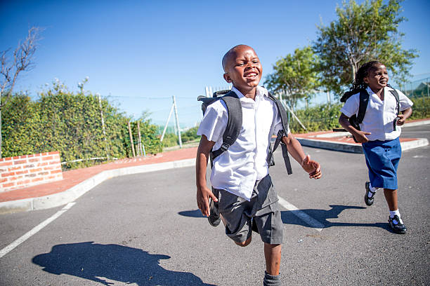 African School kids African primary school kids in theirs uniforms going to school. Image from South Africa. school boy in uniform stock pictures, royalty-free photos & images