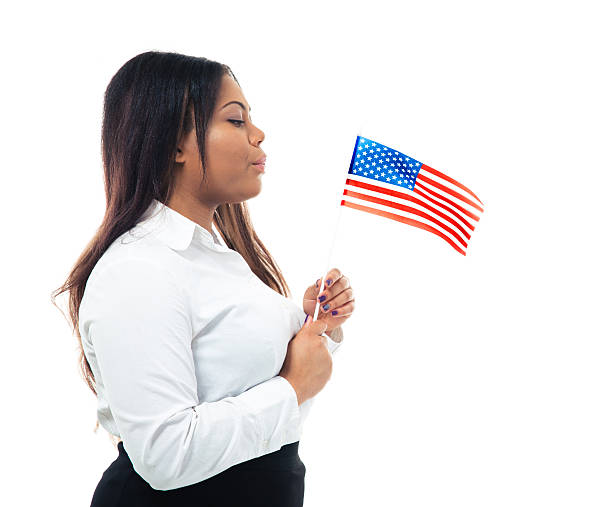istock African businesswoman blowing on US flag 481002218