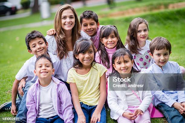 Happy Teacher With Her Students Stock Photo - Download Image Now - Adult, Beautiful People, Beauty