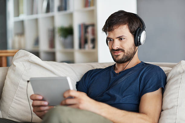 istock Listening to music on his new tablet 481004091