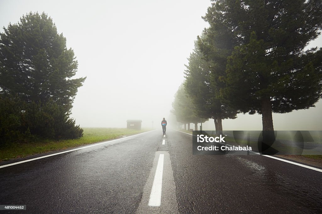 Lonely man Lonely man is walking in mysterious fog  2015 Stock Photo