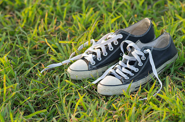 istock Old black sneakers on the grass at daytime outdoors 481006814