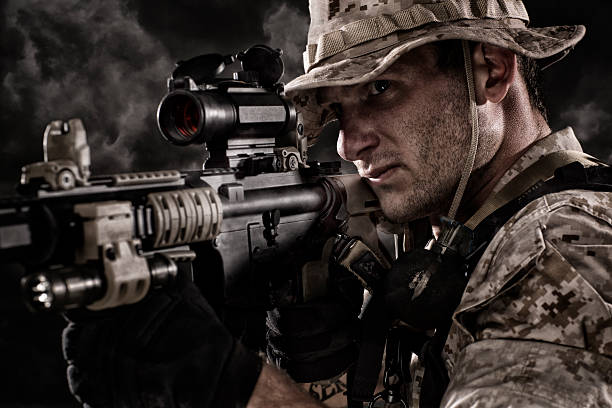 Military Sniper prepares to take a shot. This stock image has a horizontal composition.