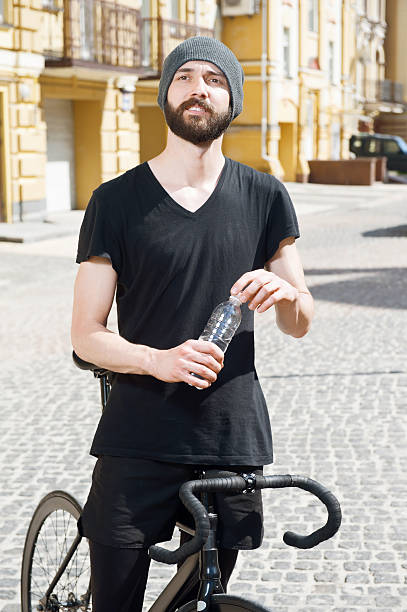 istock Attractive young hipster guy is cycling in city 481009520
