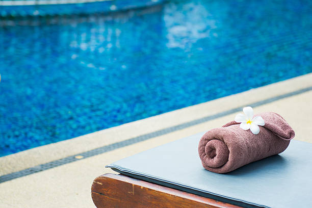 istock brown roll towel with plumeria on beach chair 481014298