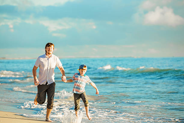 istock Father and son having great family time at ocean shore 481014410