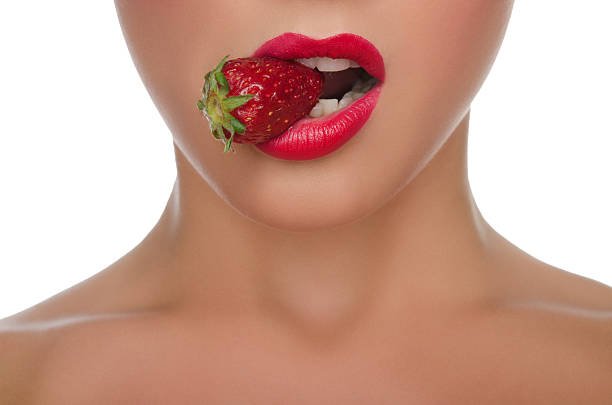 istock beautiful female lips with strawberries 481014414