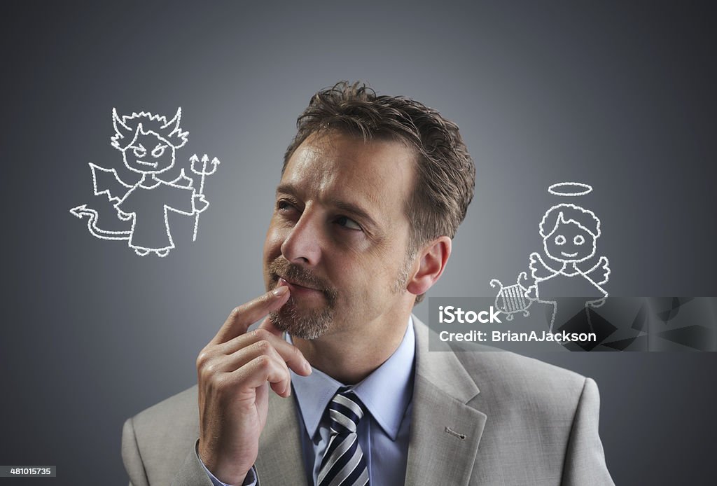 Business decisions Businessman with chalk drawing angel and devil on his shoulders concept for conscience, decisions, uncertainty or moral dilemma Evil Stock Photo