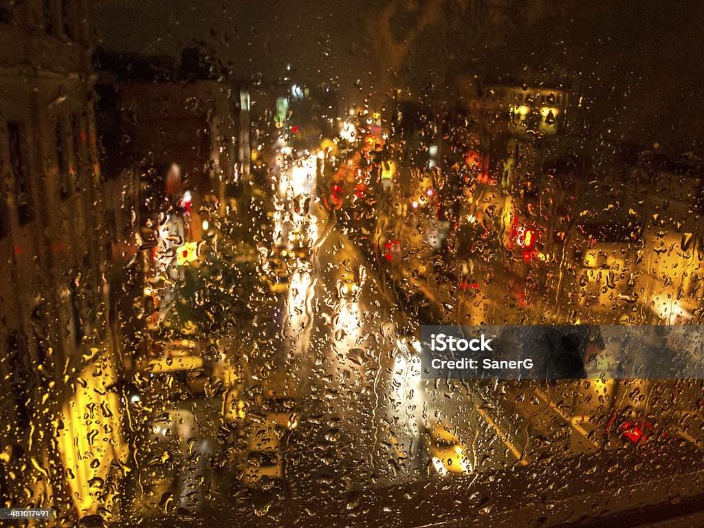 Raindrops and traffic lights at night Driving Stock Photo