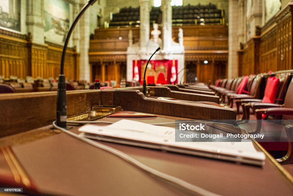Close Up of Senator's Desk in the Canadian Senate Close up of a Senator's desk with paperwork.  Image taken in the chambers of the Senate of Canada, in the Parliament Buildings in Ottawa, Canada.  The Speaker's chair can be seen in the background.  A narrow depth off field has been applied to this image. Canada Stock Photo