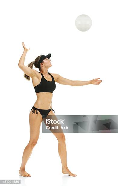 Female Volleyball Player Serving The Ball Stock Photo - Download Image Now - Athlete, Beach Volleyball, 20-29 Years