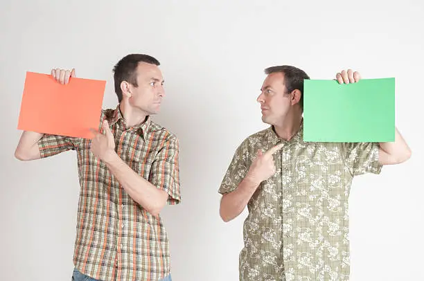 Two Men Holding a Blank Colored Paper Sheet