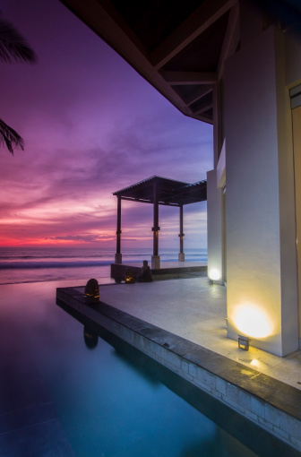 Colorful and dramatic sunset by the sea in a luxury resort.