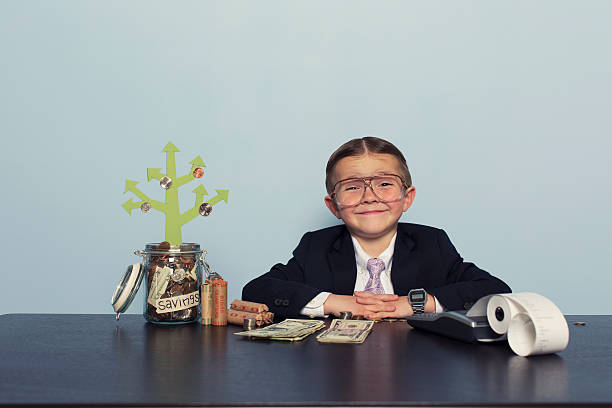 istock Young Boy Accountant Grows Money in Savings Account 481029031