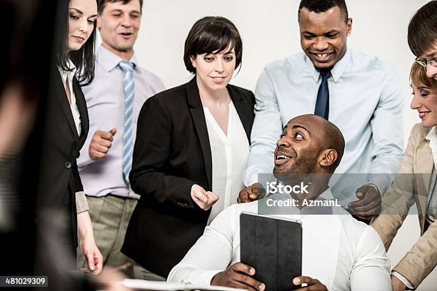 Several Business Men And Women Meeting In An Office Stock Photo - Download Image Now