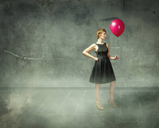 istock woman play with red balloon 481031339
