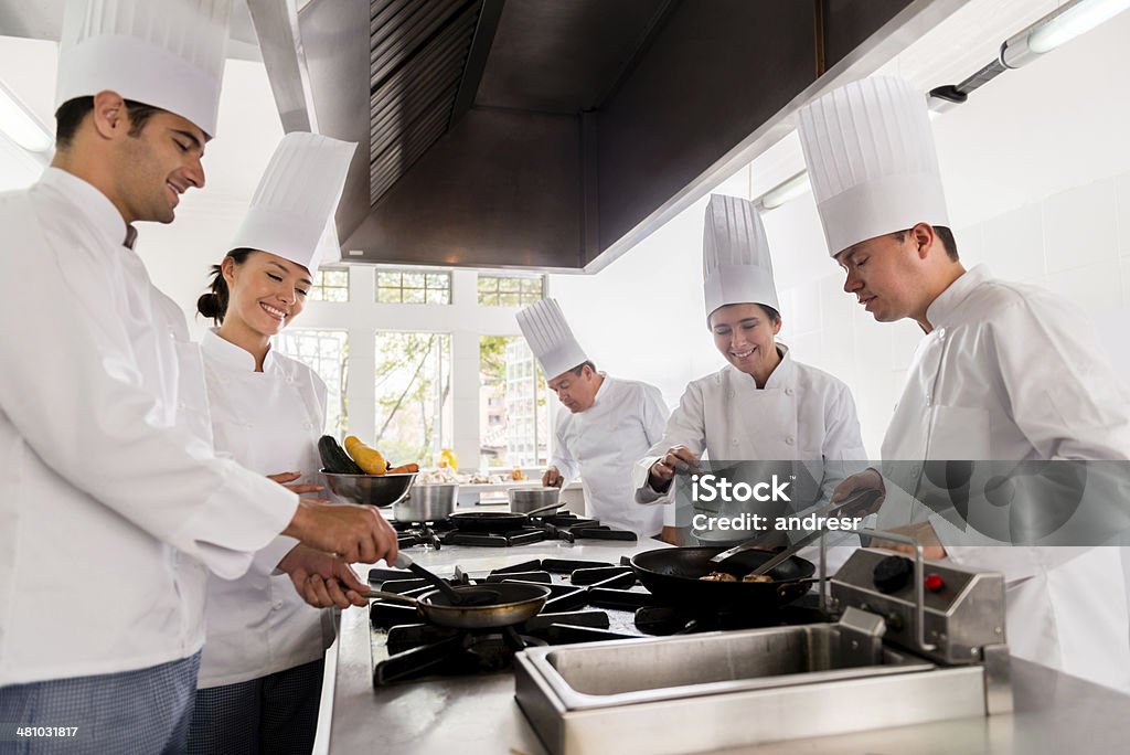 Group of chefs cooking Happy group of chefs cooking and learning Chef Stock Photo