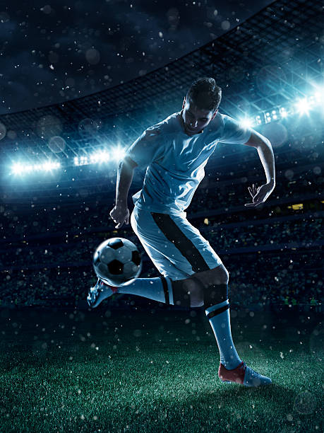 soccer player tackling a ball on stadium - world cup stok fotoğraflar ve resimler