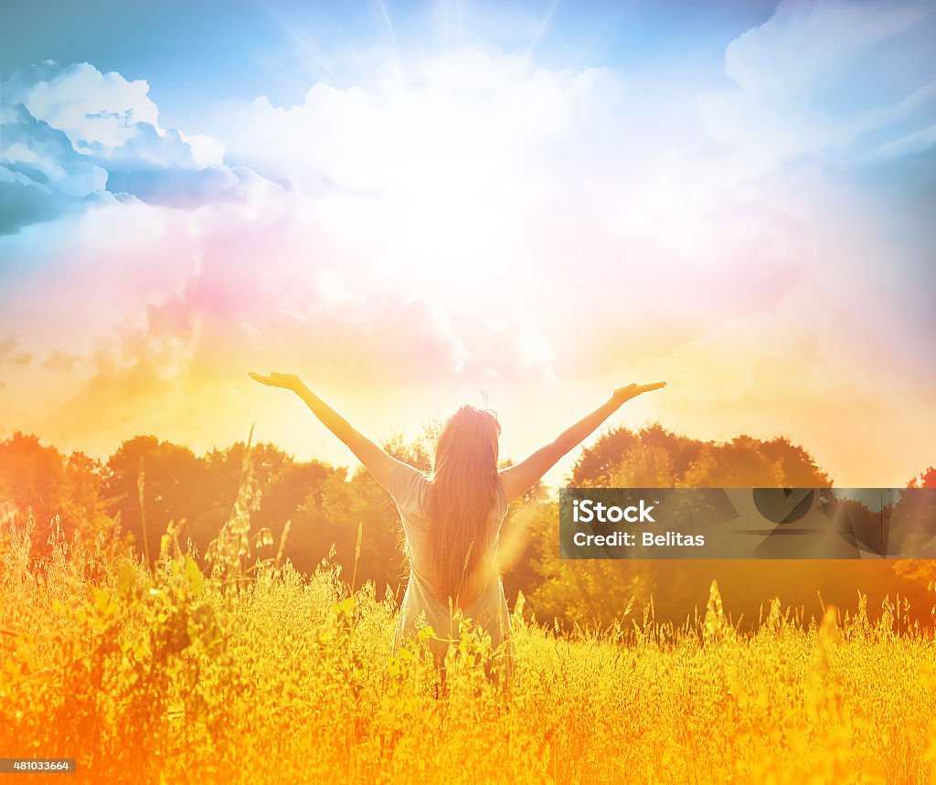 Happy girl enjoying the happiness on sunny meadow Happy woman in wreath outdoors summer enjoying life opening hands. Sunny meadow. 2015 Stock Photo