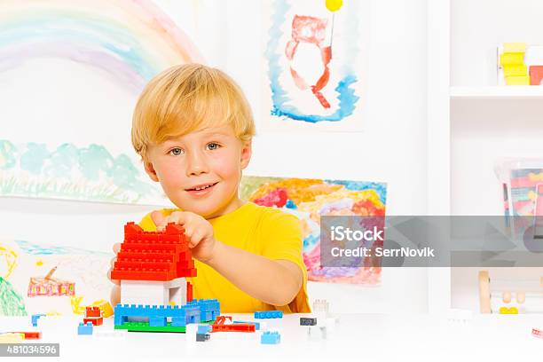 Handsome Blond Boy Building House Stock Photo - Download Image Now - 2015, Adult, Block Shape