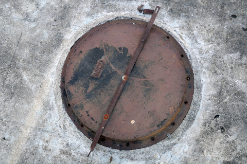 Rusty Manhole with Cement concrete background