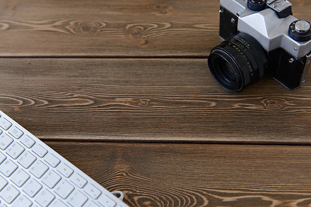 istock camera and keyboard on a dark desk background 481039608