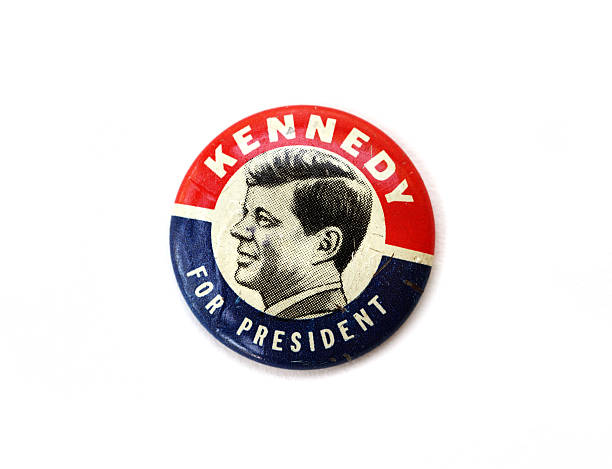 Vintage John F. Kennedy political campaign button West Palm Beach, USA - July 11, 2015: Vintage John F. Kennedy political campaign pin from the 1960 presidential race between Kenney and Nixon. John F. Kennedy became the 35th President of the United States.  campaign button photos stock pictures, royalty-free photos & images