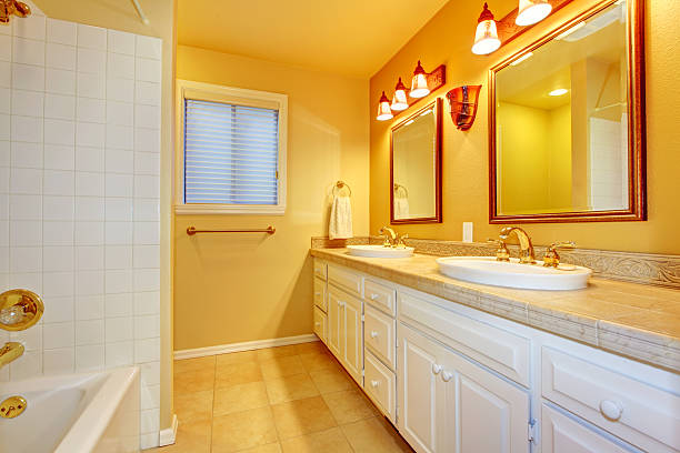istock Bathroom with white cabinets and gold yellow walls. 481043355