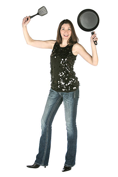 istock woman holding cooking utensils pan spatula 481044979