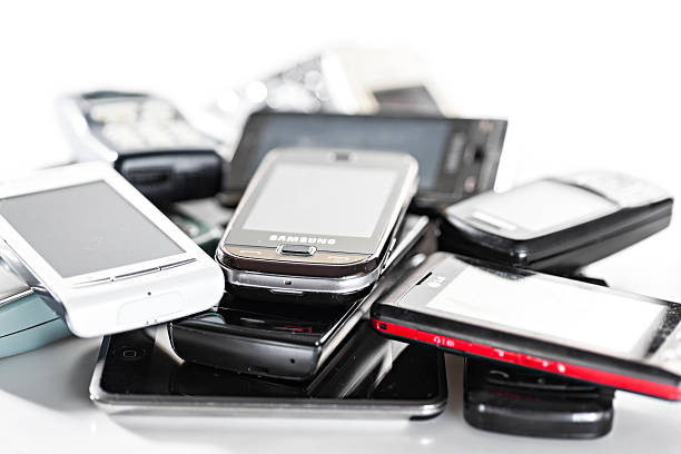 Old used cellphones pile stock photo