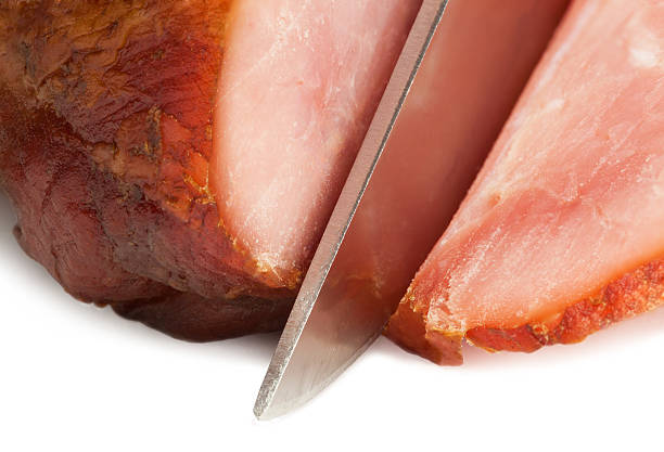 Knife cutting dried meat isolated on white background with clipping path