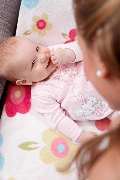 istock Happy baby lying on back smiling at mother 481049195