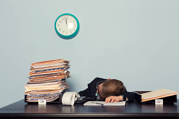 istock Exhausted Boy Businessman Lays on Office Desk 481054115