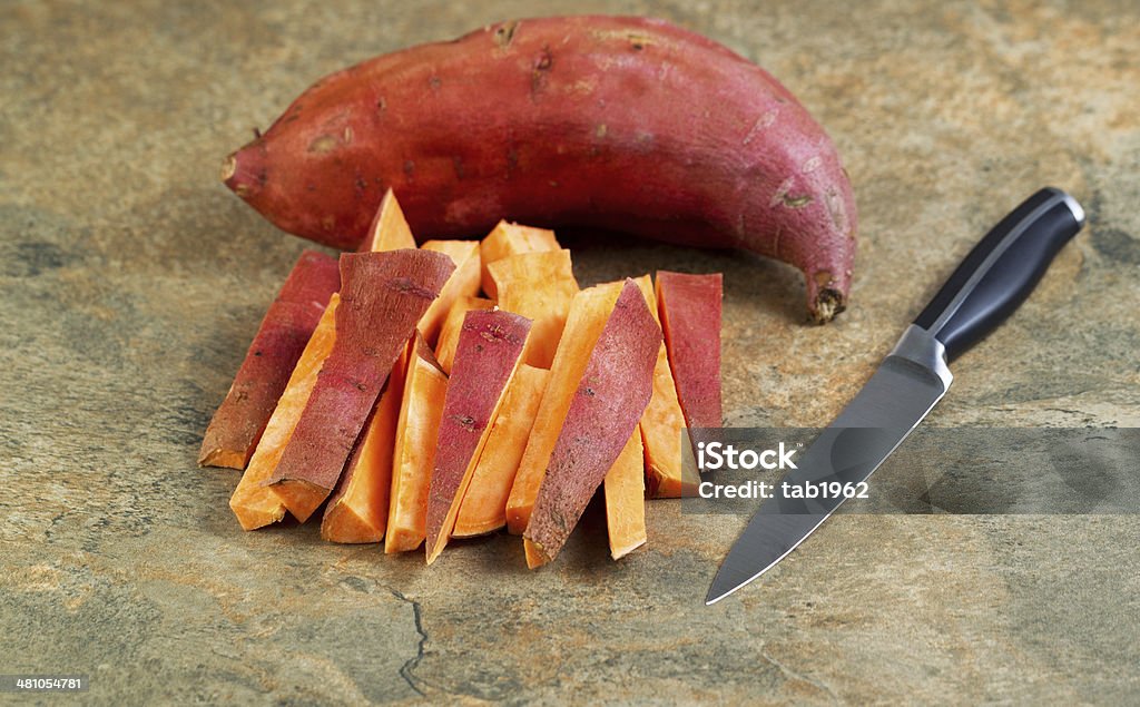 Fresh Yams for Cooking Horizontal photo of freshly cut Yams for cooking with knife and stone board Agriculture Stock Photo