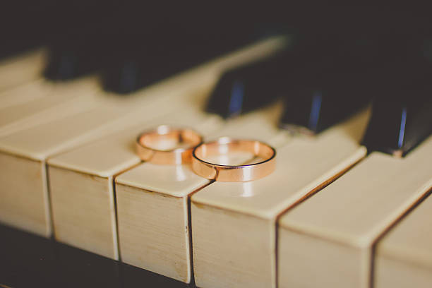istock Wedding golden rings on vintage piano 481054924