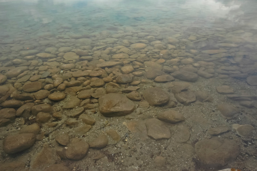 round stones under clear lake