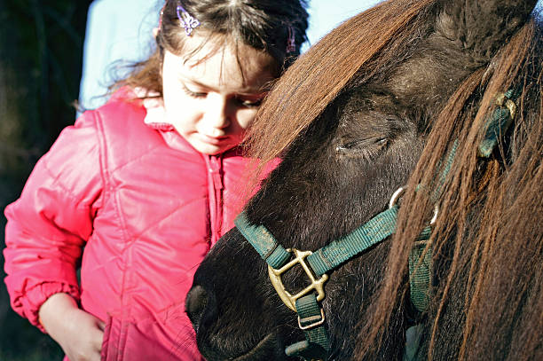 istock little girl and her pony 481055963