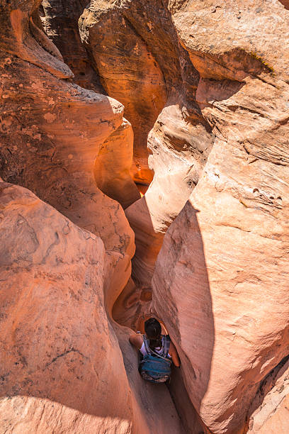 istock Girl Hiker Backpacker Climbing down the Slot Canyon 481061018