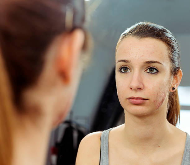 istock teenager looking in the mirror 481062175