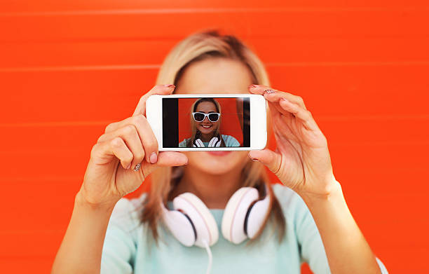 istock Pretty girl makes self-portrait on the smartphone outdoors again 481063272
